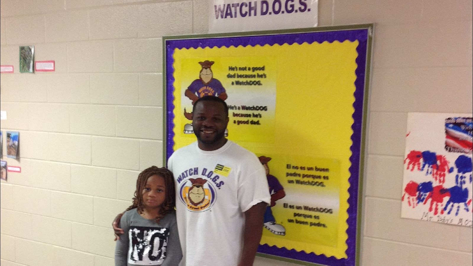 father and child in front of a WatchDOG bulletin board